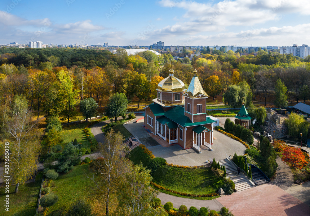 Church of the Archangel Michael in Gomel. Temple in the Festivalny park. Yellow autumn park.