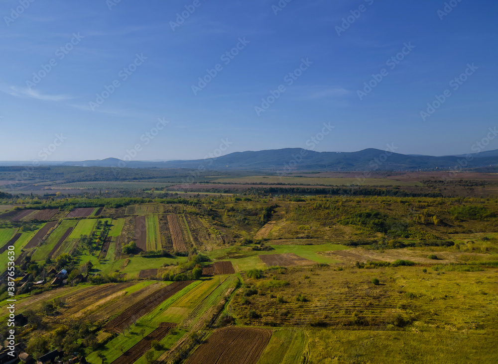 Aerial view of green farmland cultivated field from of the countryside