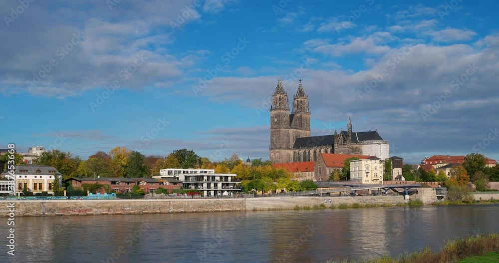 Historical and shopping downtown of Magdeburg, old town, Elbe river and Magnificent Cathedral at golden Autumn, Germany, with blue sky and clouds Historical and shopping downtown of Magdeburg, old town, Elbe river and Magnificent Cathedral at golden Autumn, Germany, with blue sky and clouds