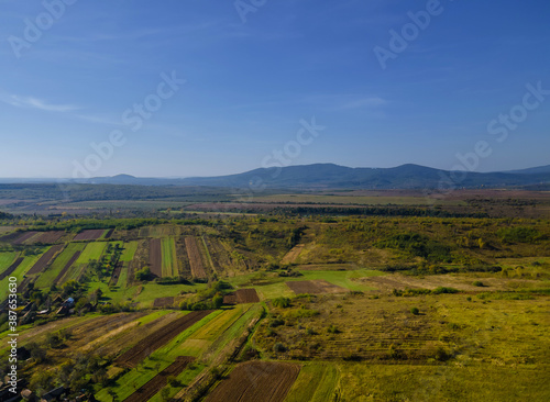 Aerial view of green farmland cultivated field from of the countryside