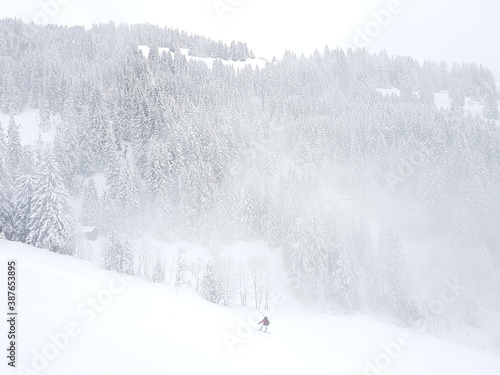 Snowboarder in fog on mountains