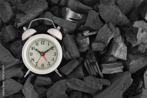 Wallpaper Mural White retro alarm clock on black charcoal background with copy space. Top view Torontodigital.ca