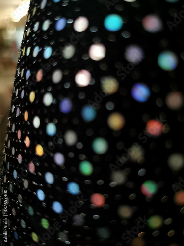 Black multicolor glitter sequin background. Sequin texture fabric. Shiny glitter background. selective focus, blurred filter photo