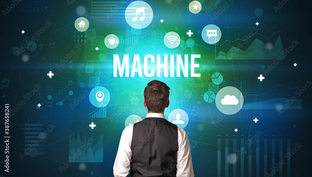Rear view of a businessman with MACHINE inscription, modern technology concept Rear view of a businessman with MACHINE inscription, modern technology concept