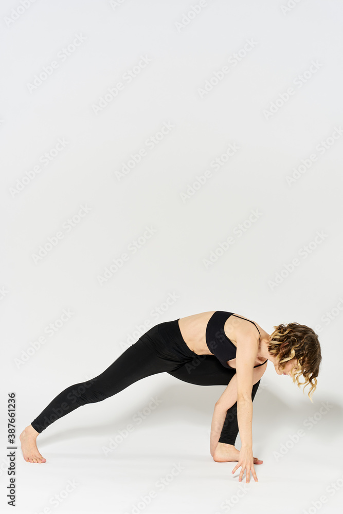 Woman in sportswear is engaged in fitness indoor gymnastics slim figure Woman in sportswear is engaged in fitness indoor gymnastics slim figure