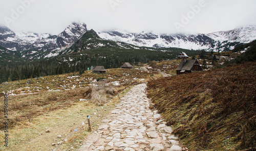 Obraz na płótnie Path to old wooden village in the mountains parks in autumn, winter in Tatry, Poland. Christmas landscape of social distance simple living, no civilization area and solitude. w salonie