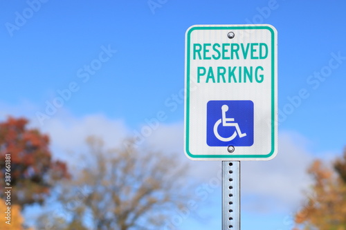 USA road sign disabled parking on autumn sky background