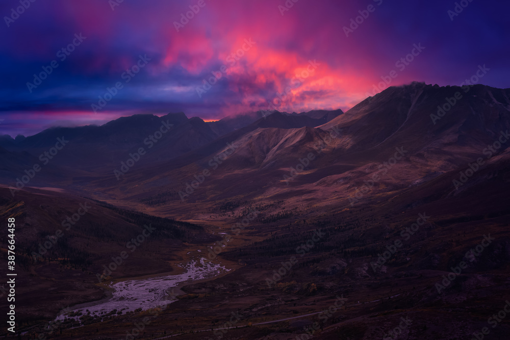 Beautiful Aerial View of Scenic Landscape on a Fall Season in Canadian Nature. Colorful Twilight Sky Artistic Render. Taken in Tombstone Territorial Park, Yukon, Canada. Beautiful Aerial View of Scenic Landscape on a Fall Season in Canadian Nature. Colorful Twilight Sky Artistic Render. Taken in Tombstone Territorial Park, Yukon, Canada.