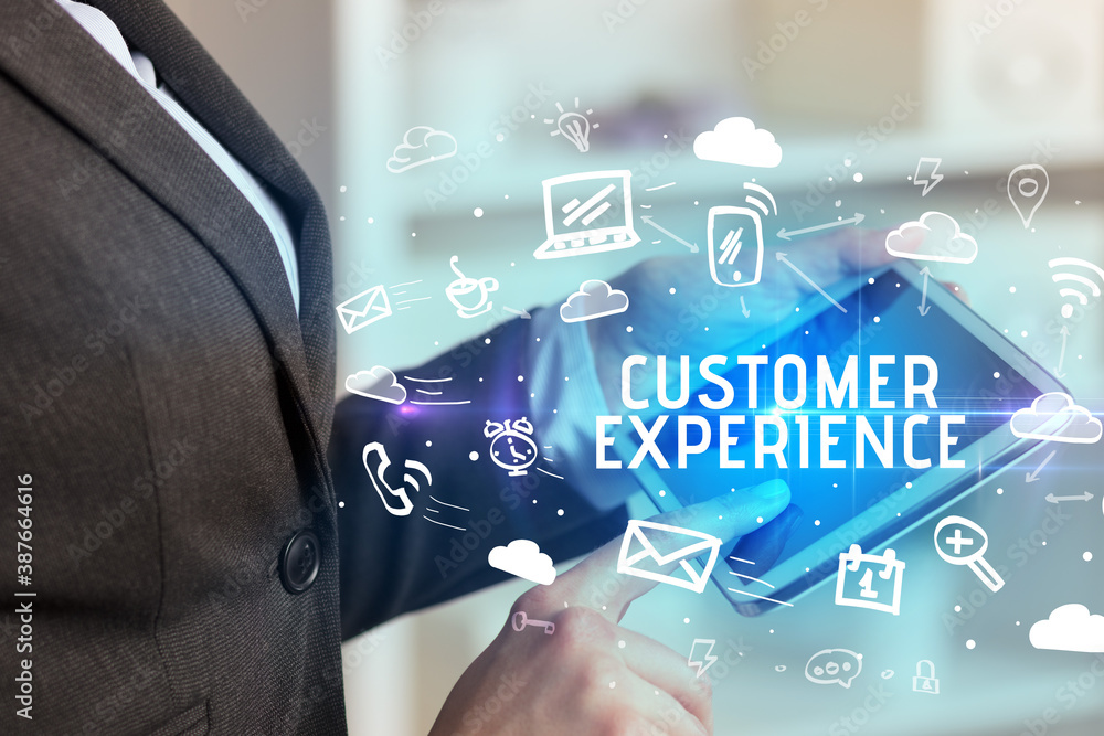 Close-up Of A Person Using Social Networking with CUSTOMER EXPERIENCE inscription Close-up Of A Person Using Social Networking with CUSTOMER EXPERIENCE inscription
