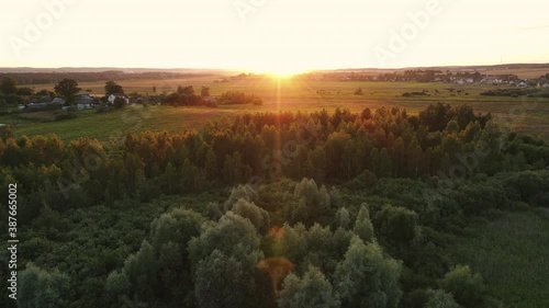 Aerial view of colorful sunset among countryside and fields