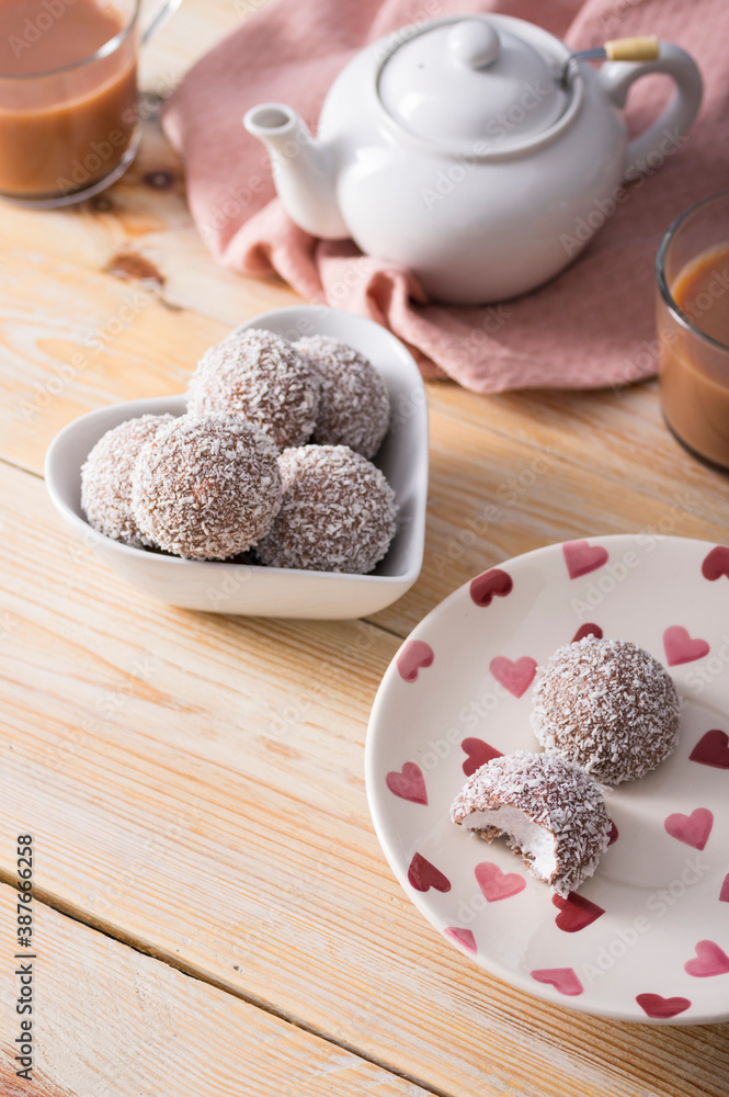 Tea cakes of soft melting marshmallow centre, chocolate and coconut coated Tea cakes of soft melting marshmallow centre, chocolate and coconut coated