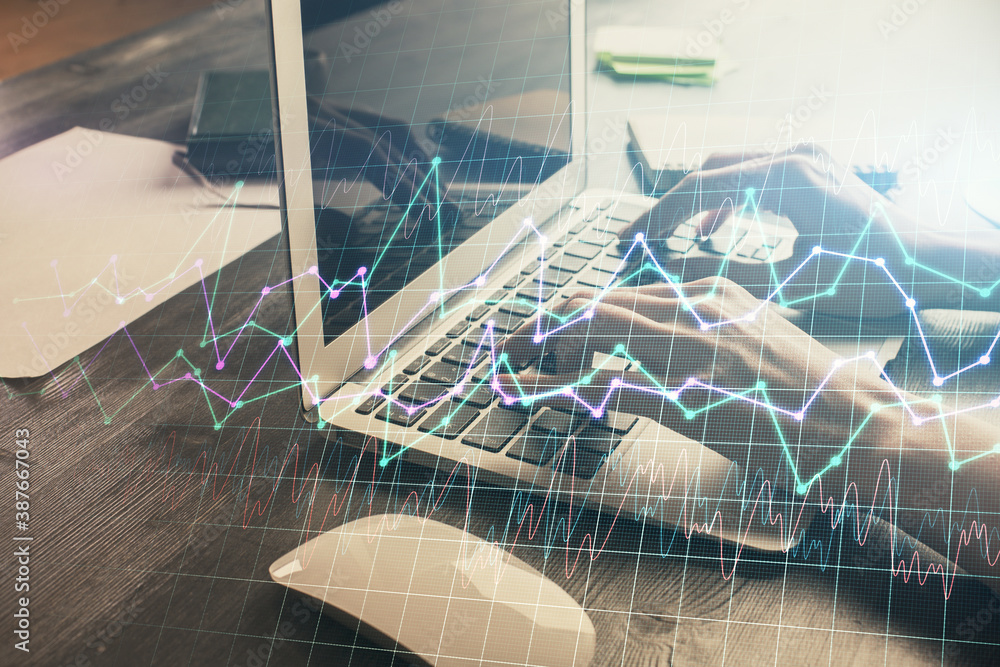 Double exposure of woman hands typing on computer and forex chart hologram drawing. Stock market invest concept.