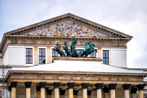 Warszawa Grand National Opera or Teatr Narodowy in Warsaw, Poland downtown with statue sculpture of Apollo on horse drawn chariot with relief pediment architecture