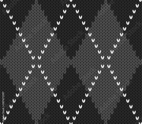 Knitted argyle Halloween pattern. Wool knitinng. Scottish plaid in gray and black rhombuses. Traditional  Scottish background of diamonds . Seamless fabric texture. Vector illustration