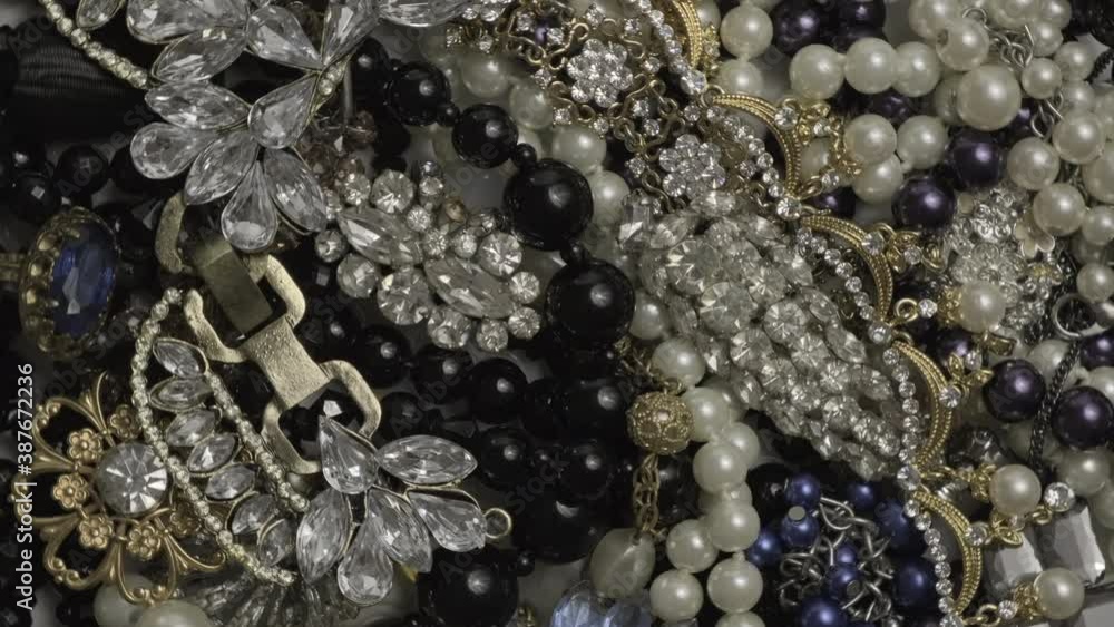 Jewelry. Rotating seamless loop background from many beautiful female fashion jewel with precious shiny stones, pearls and diamonds for women. Wealth and luxury concept, closeup, macro. Loop motion Jewelry. Rotating seamless loop background from many beautiful female fashion jewel with precious shiny stones, pearls and diamonds for women. Wealth and luxury concept, closeup, macro. Loop motion