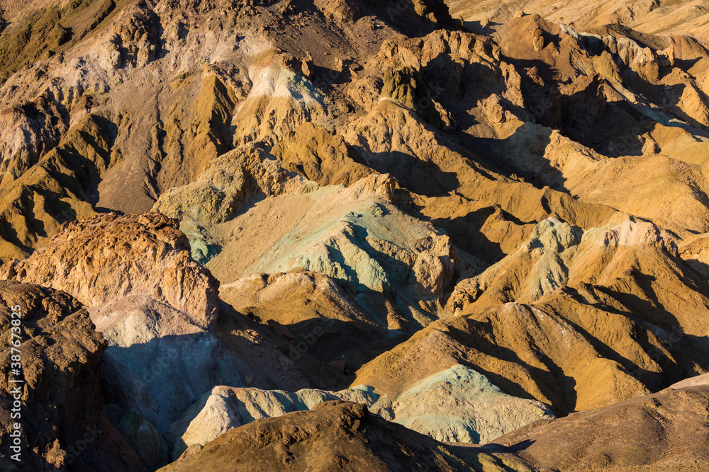 Stunning landscape view of the colorful rock formations of Artist's Pallete during susnet in Death Valley National Park (California).
