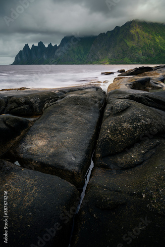 Devil's teeth in distance, popular rocks on the island of Senja, Northern Norway. photo