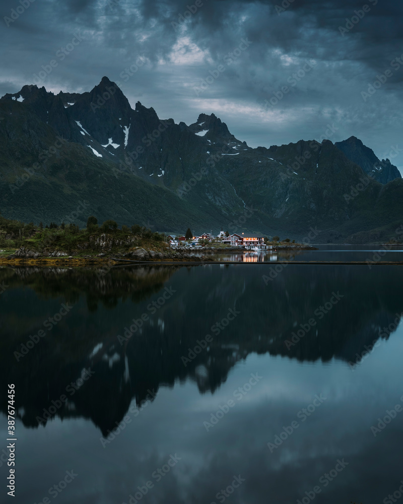 Lofoten islands at night in Northern norway, mountains with reflections in fjords lake