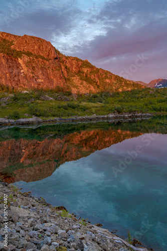 Lofoten archipelago, reflection in water during colourful sunset in Northern Norway, Lofoten.