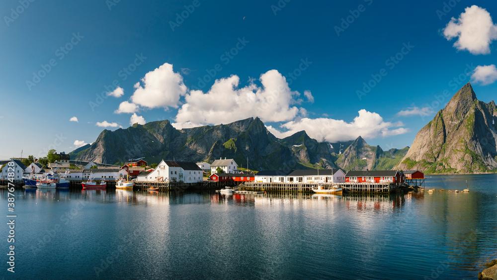 Beautiful, colourful, bright day in Reine fishing village and mountains in background in Lofoten archipelago, Norway.