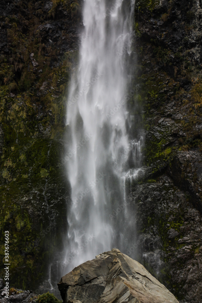 Fototapeta premium waterfall and a rock