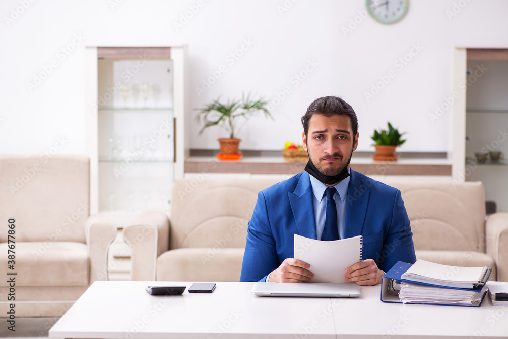 Young male employee in self-quarantine concept Young male employee in self-quarantine concept
