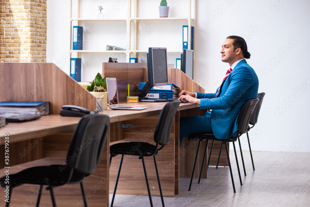 Young male employee working in the office