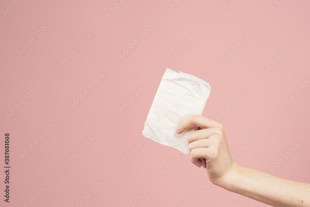 Laying in packaging in female hands on a pink background cropped view hygiene clean appearance Laying in packaging in female hands on a pink background cropped view hygiene clean appearance