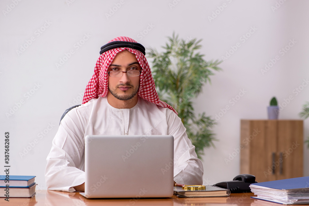 Young male arab employee working in the office Young male arab employee working in the office