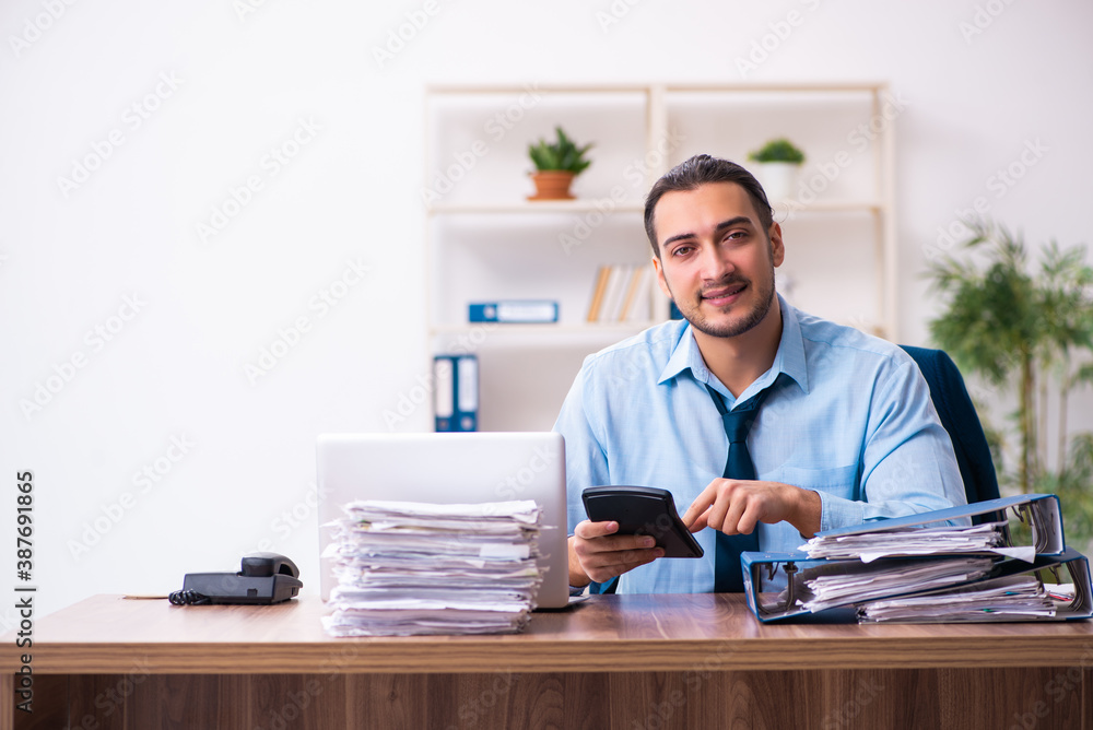 Young male businessman employee working in the office Young male businessman employee working in the office