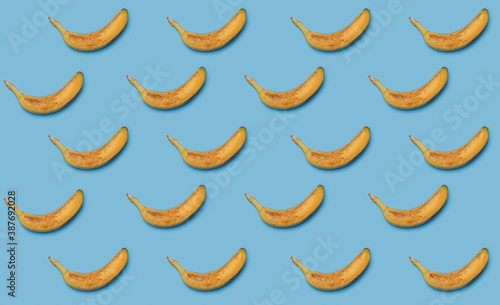 many yellow ripe bananas isolated on blue background pattern