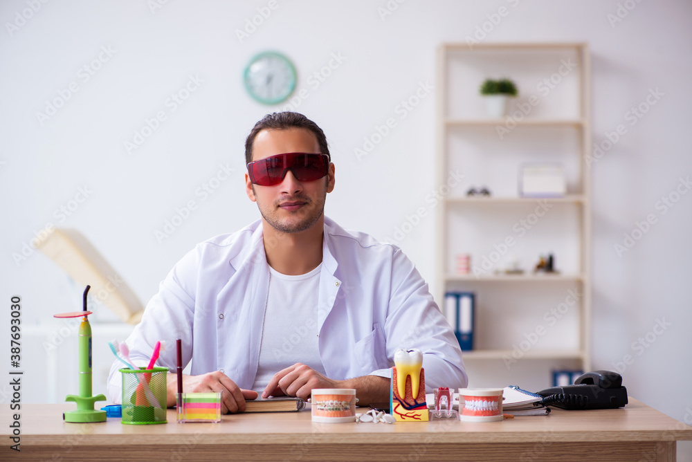 Young male dentist working in the clinic Young male dentist working in the clinic