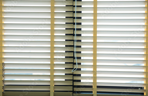 Wooden blinds with daylight illuminating through