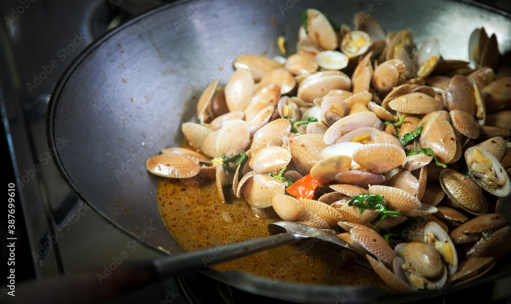 frying chilly curry with shell in hot pan with herb frying chilly curry with shell in hot pan with herb
