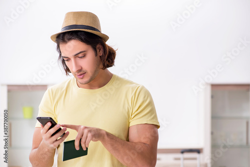 Young man holding passport preparing for summer trip