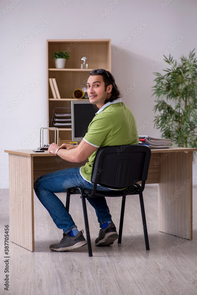 Young male designer working in the office Young male designer working in the office
