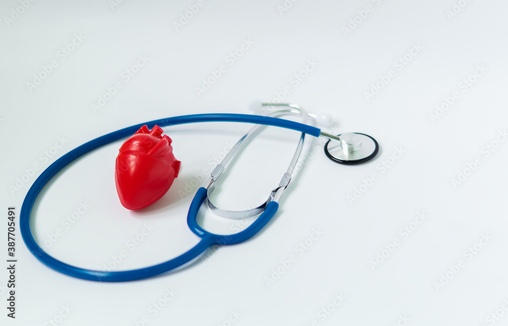 Red heart and blue stethoscope on white background. Concept of cardiology Red heart and blue stethoscope on white background. Concept of cardiology