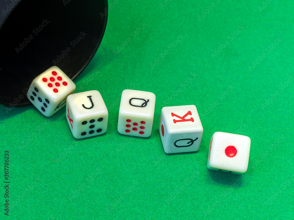 A royal flush by poker dice on the green table. A royal flush by poker dice on the green table.