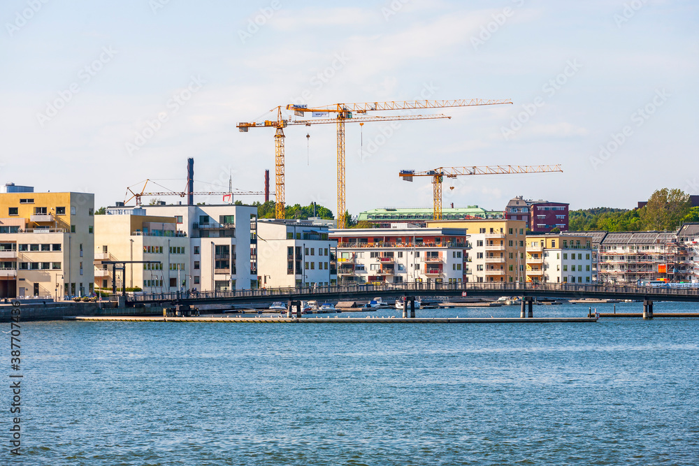Residential area with construction cranes by the water