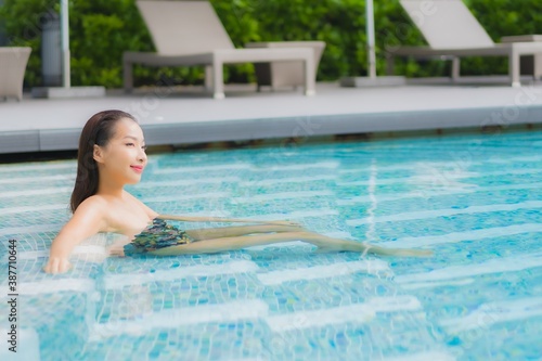 Portrait beautiful young asian woman relax smile around outdoor swimming pool