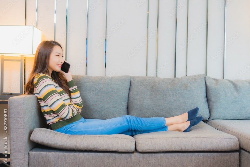 Portrait beautiful young asian woman use smart mobile phone on sofa Portrait beautiful young asian woman use smart mobile phone on sofa