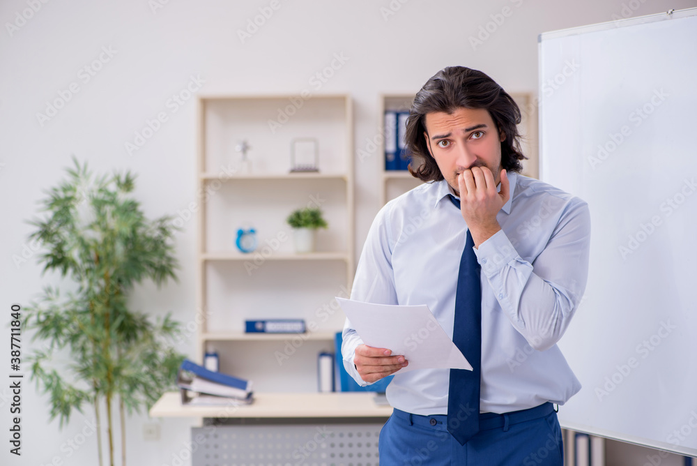 Young man employee in business presentation concept Young man employee in business presentation concept