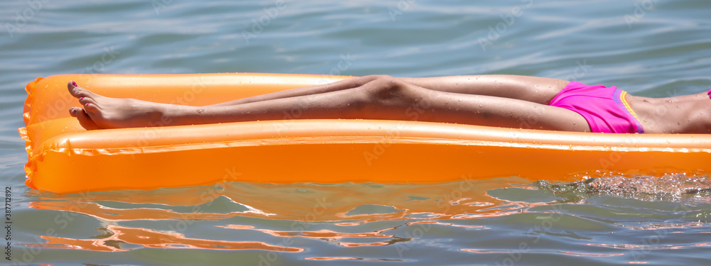 The girl swims with an inflatable mattress