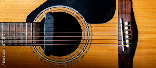 Close up sound hole and bridge acoustic guitar