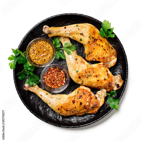 Grilled chicken legs with spices isolated on white background