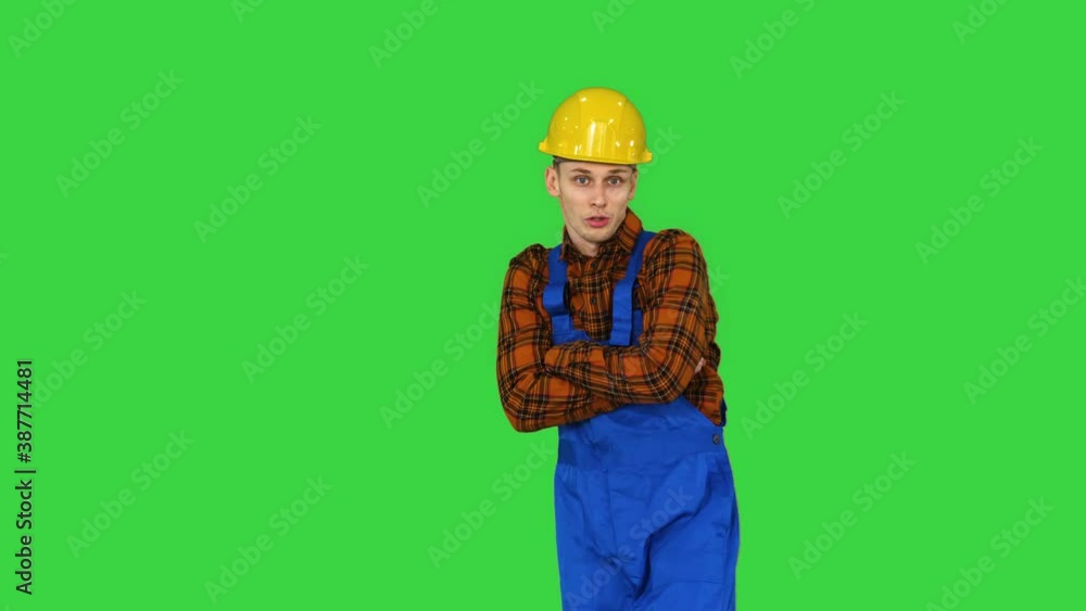 Construction worker making a flip and folds hands looking to camera The best construction concept on a Green Screen, Chroma Key. Construction worker making a flip and folds hands looking to camera The best construction concept on a Green Screen, Chroma Key.