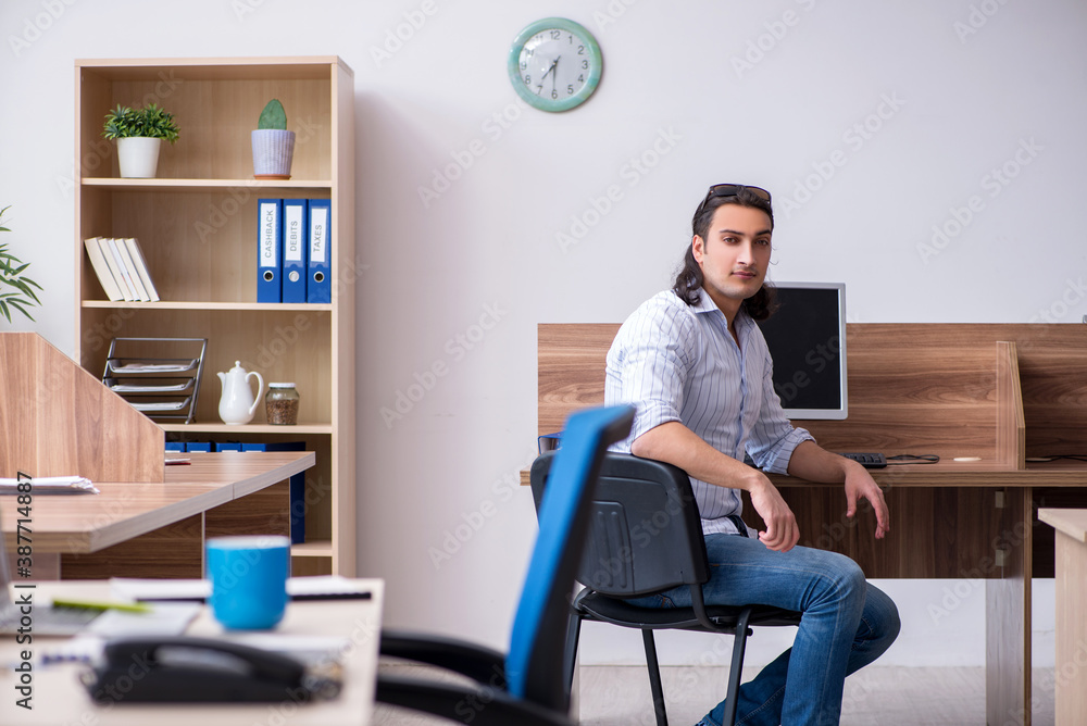 Young male businessman employee working in the office