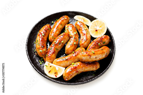Homemade chicken sausages fried and stewed in garlic butter sauce. isolated on white background 