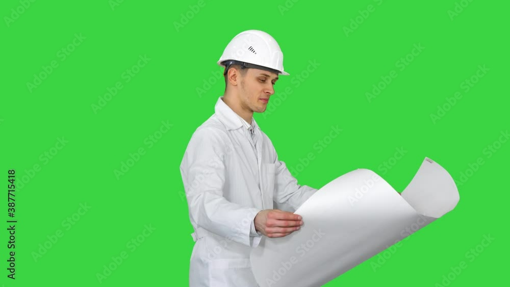 Engineer dancing with a blueprint being in a good mood on a Green Screen, Chroma Key. Engineer dancing with a blueprint being in a good mood on a Green Screen, Chroma Key.