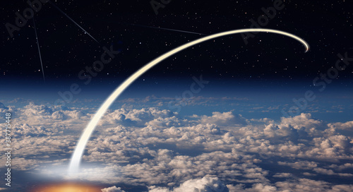 Long exposure night time rocket launch, falling stars in the background - Planet Earth with a spectacular sunset - "Elements of this image furnished by NASA" 